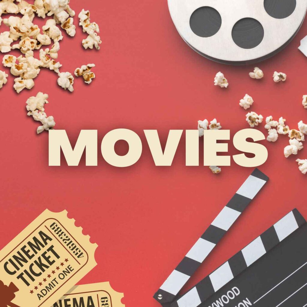 Flat lay of cinema essentials including popcorn, movie tickets, and a clapperboard on a red background for upcoming movie updates.